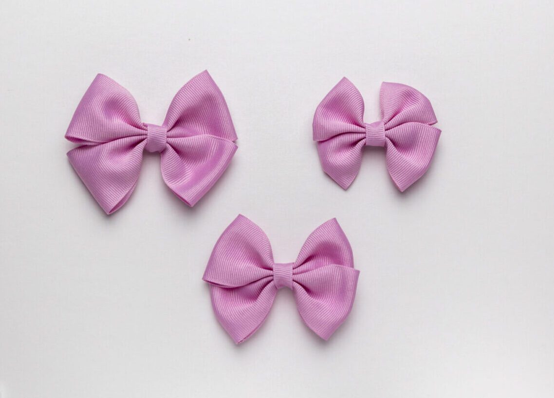 A Lilac Color Bow on a White Background